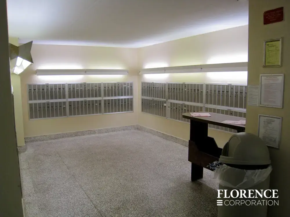 Double row of 1250 series vertical 4B+ mailboxes in anodized aluminum installed inside large apartment mailroom