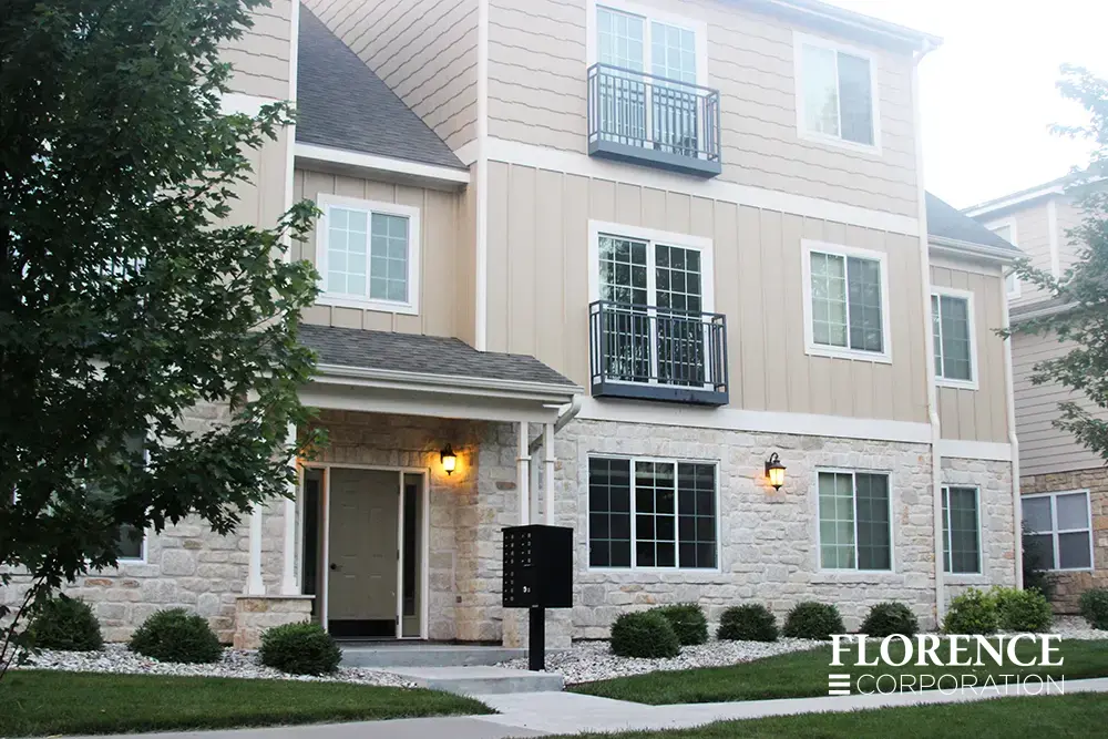 Single vital&trade; cluster box unit in black installed along front entrance sidewalk of multifamily apartment building