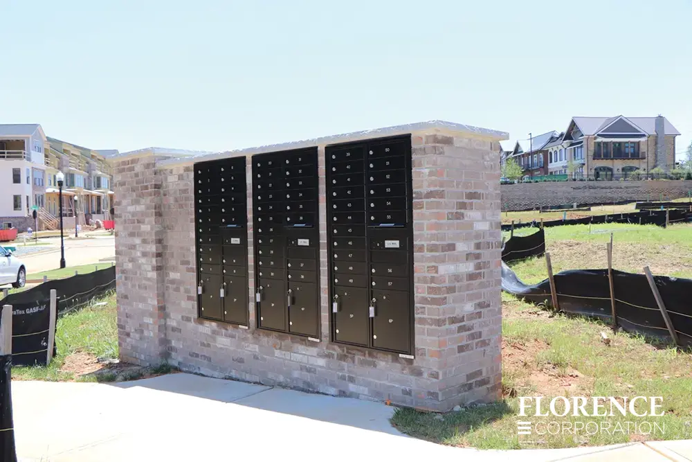 recessed mounted versatile&trade; 4C mailboxes in black placed in brick of new construction community