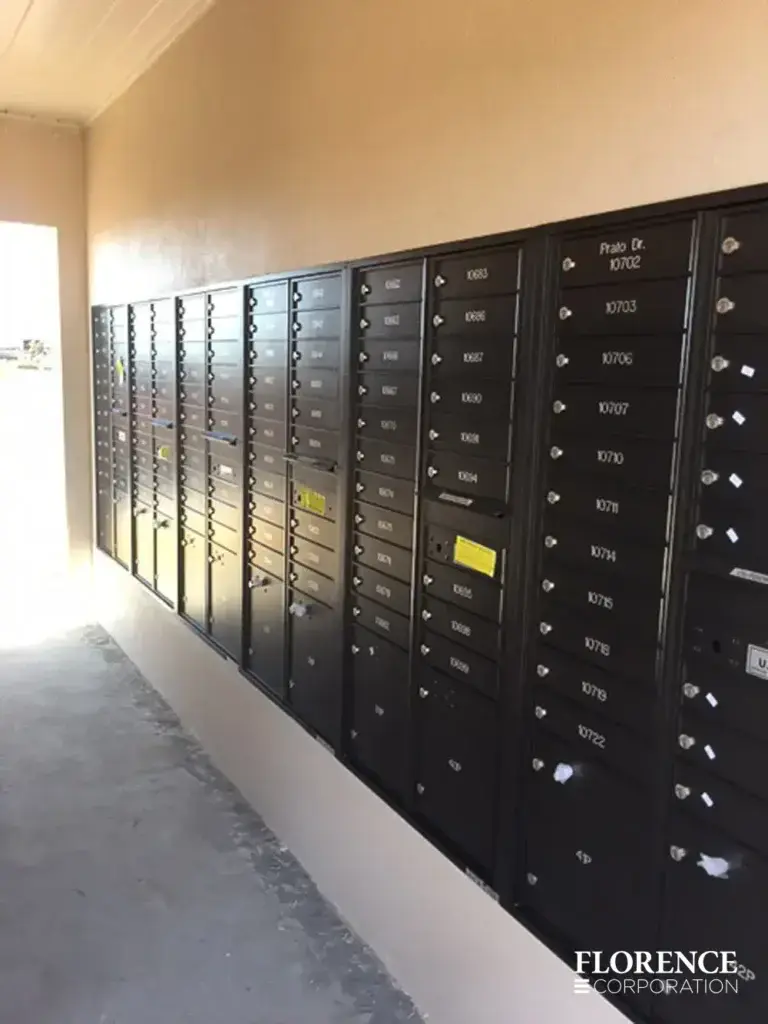 recessed mounted versatile&trade; 4C mailboxes in black mounted in wall of multifamily community breezeway