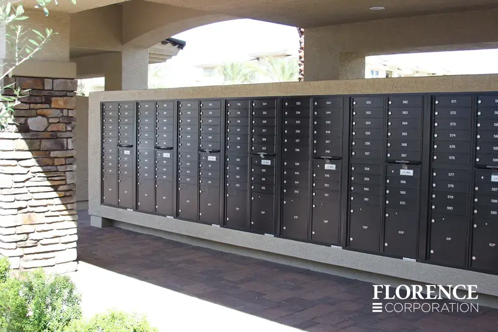 recessed mounted versatile&trade; 4C mailboxes in black mounted in cream stucco near stone column in covered area