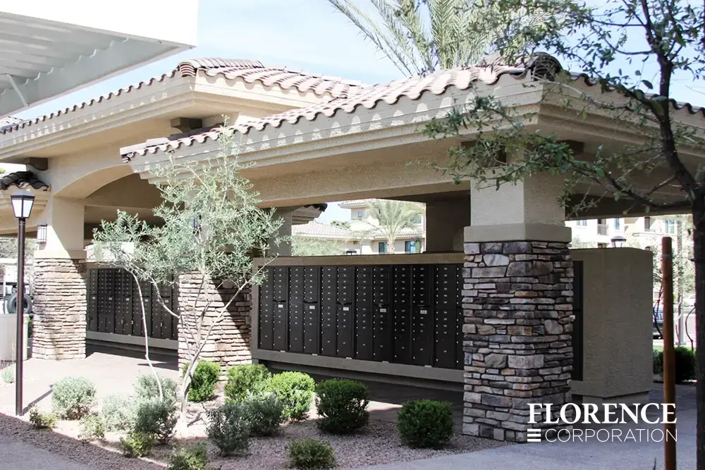 recessed mounted versatile&trade; 4C mailboxes in black under tile covered center with stone columns