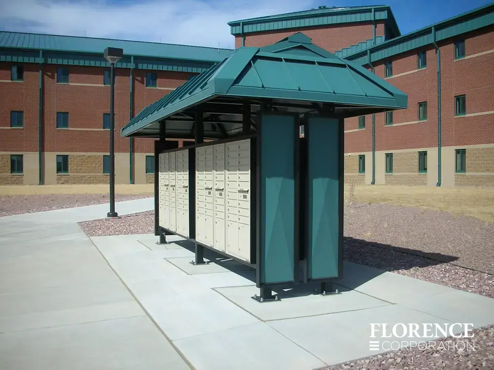 recessed mounted versatile&trade; 4C mailboxes in sandstone installed in green metal weather protected fixture outside of red brick commercial building