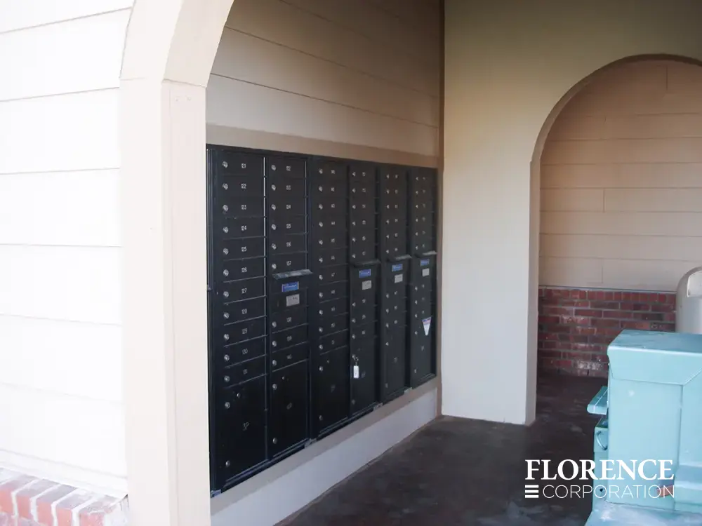 recessed mounted versatile&trade; 4C mailboxes in black in cream breezeway of multifamily apartment community building