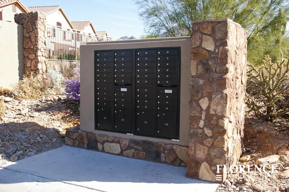 recessed mounted versatile&trade; 4C mailboxes in black installed in outdoor stone fixture in townhome community