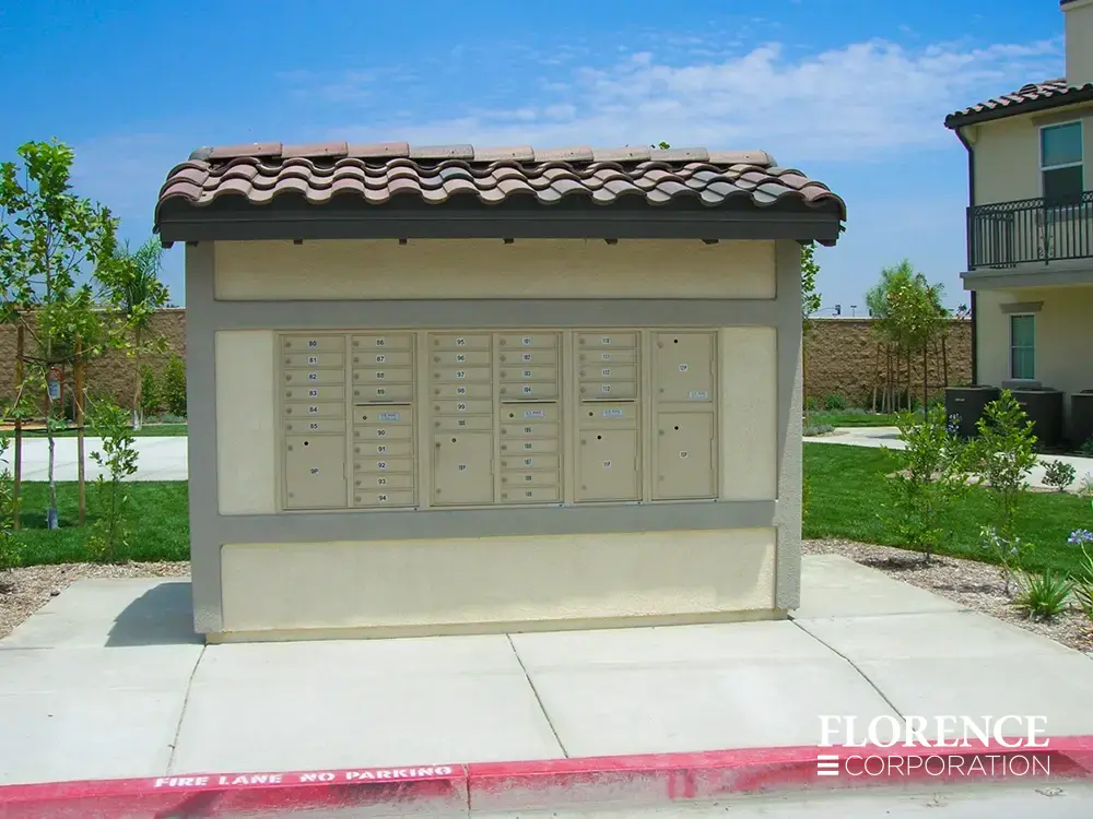 recessed mounted versatile&trade; 4C mailboxes in sandstone mounted into cream stucco building with spanish tile roof