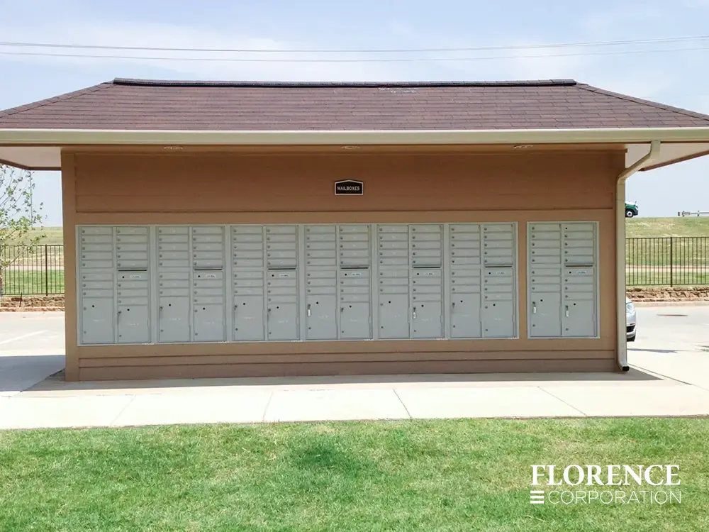 recessed mounted versatile&trade; 4C mailboxes in silver speck installed on outside of tan multifamily community building