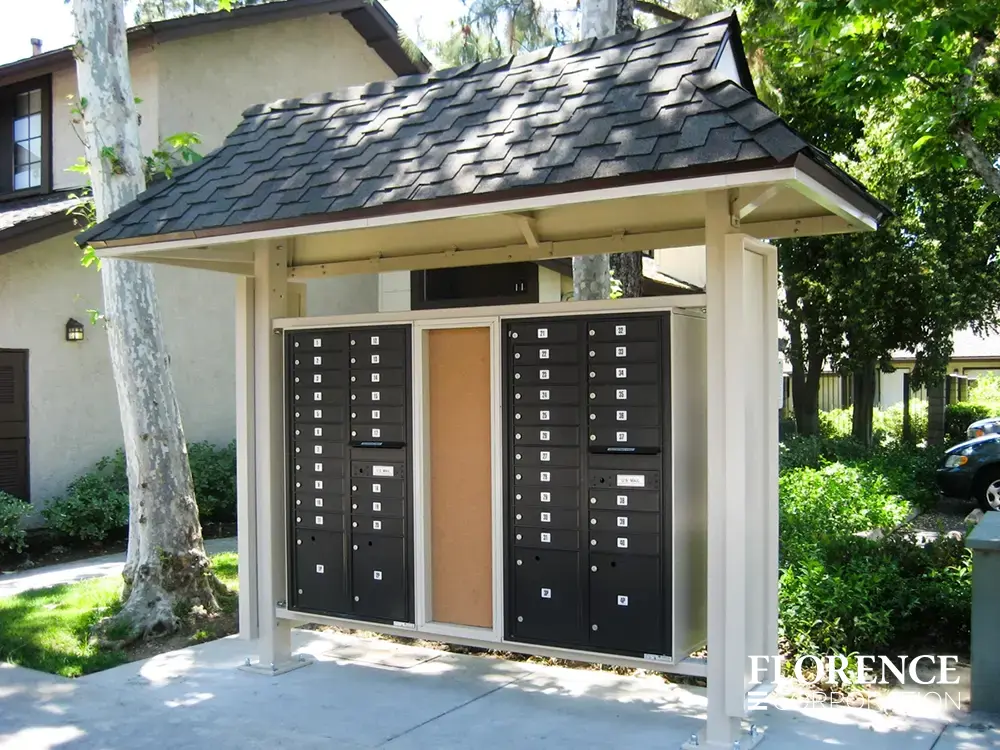 recessed mounted versatile&trade; 4C mailboxes in black installed outdoor in sandstone metal covered fixture near parking lot of townhome community