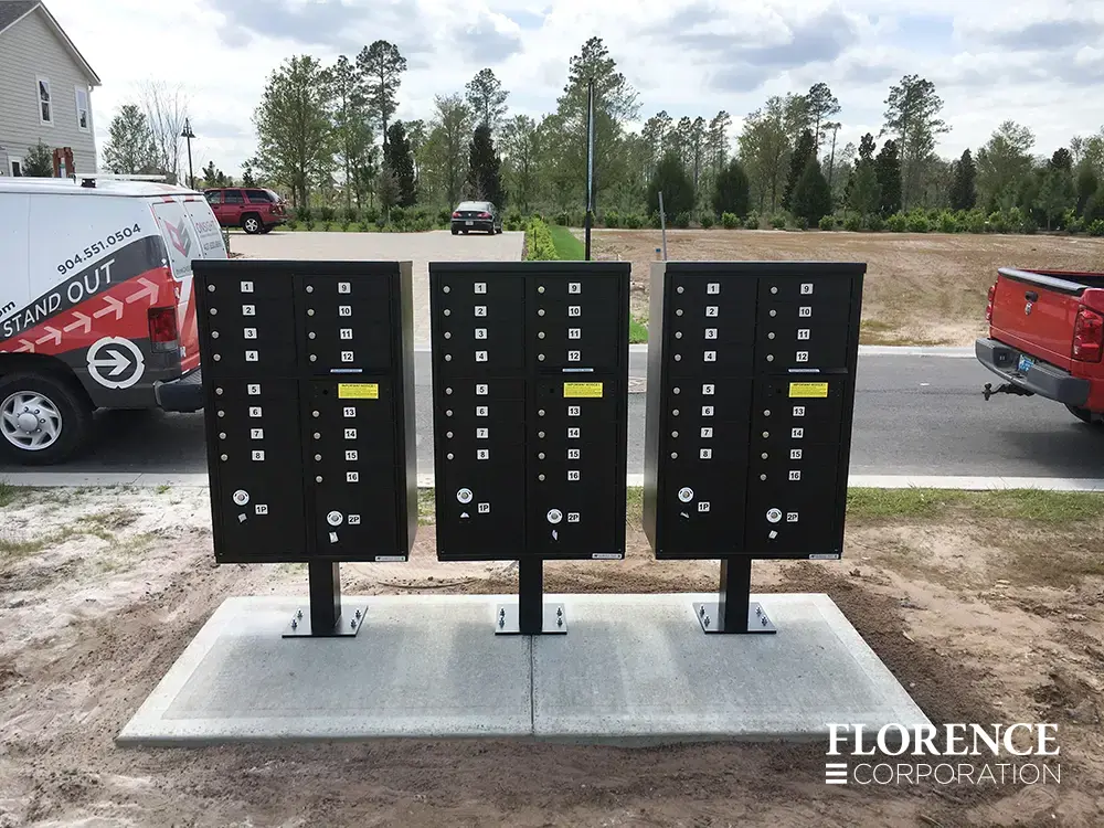 vital&trade; cluster box units in black with number decals installed on concrete slab near road in new single-family neighborhood development