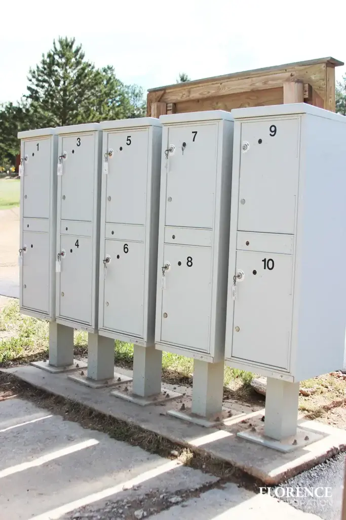 valiant-1590-OPL-series_013 valiant™ outdoor parcel lockers in postal grey installed outdoor on small concrete slab with large numbers