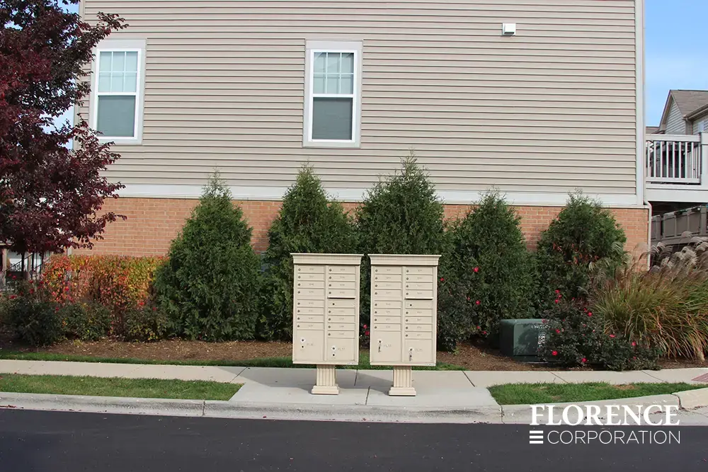 vogue-CBU-Accessories_014 vogue™ accessories on vital™ cluster box units in sandstone installed in clean modern townhome neighborhood with shrubbery landscaping in the background