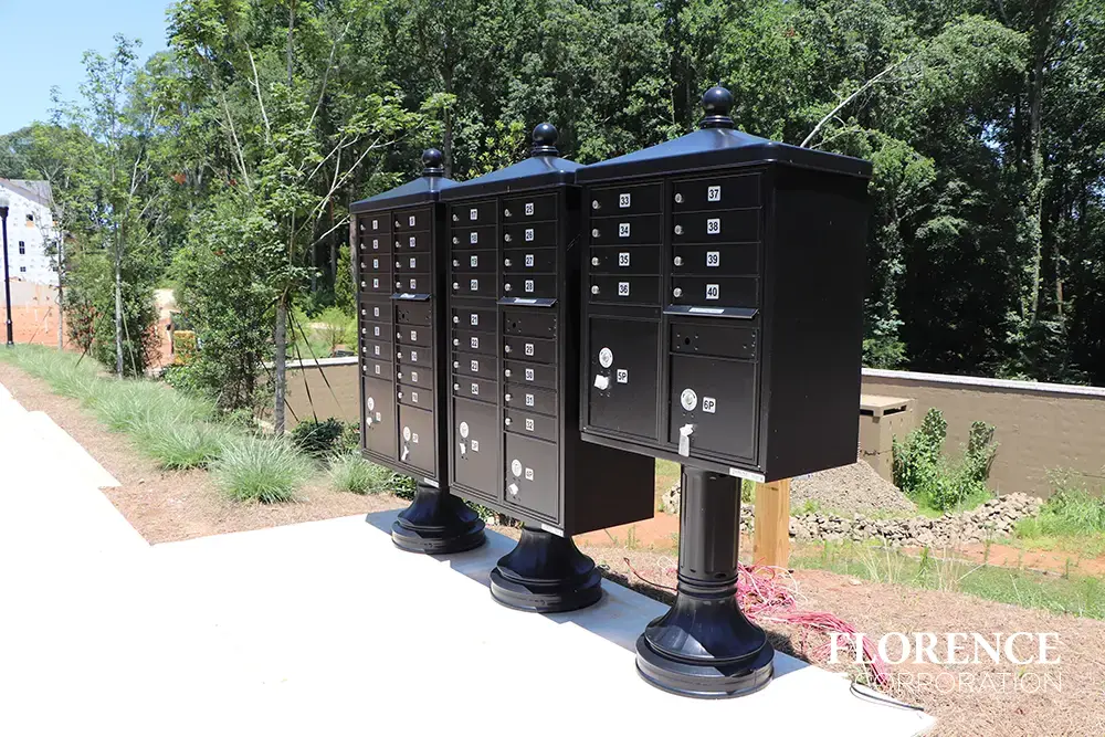 vogue-CBU-Accessories_030 vogue™ accessories on vital™ cluster box units in black installed on concrete slab in new construction development along sidewalk
