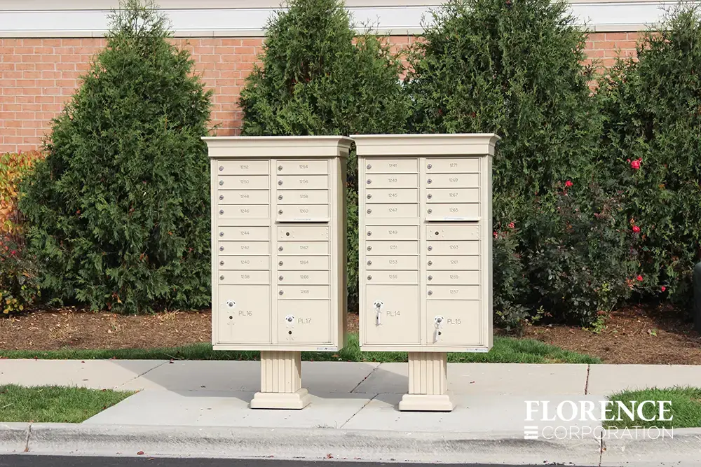 vogue-CBU-Accessories_038 vogue™ accessories on vital™ cluster box units in sandstone installed curbside in front of green foliage and flowers