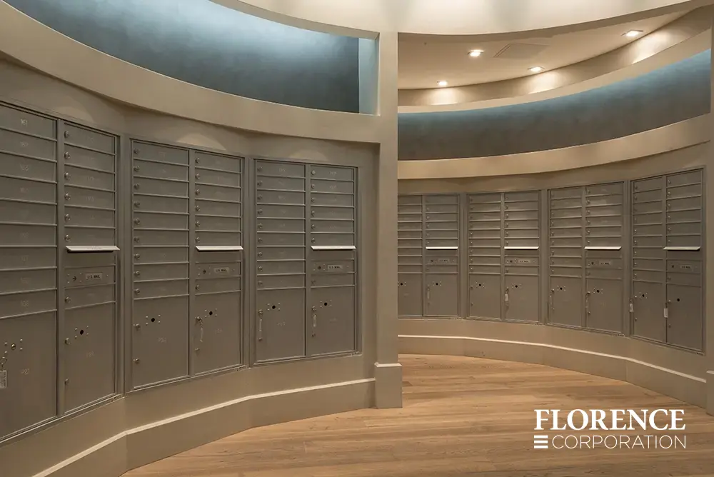 versatile-4C-indoor-install_001 multiple curved rows of recessed mount versatile™ 4C mailboxes in silver speck installed in modern apartment mailroom