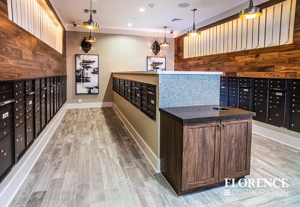 versatile-4C-indoor-install_011 Recessed mount versatile™ 4C mailboxes in black installed in contemporary mail room with wood accents, vinyl flooring, and modern light fixtures