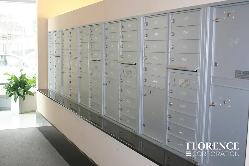 versatile-4C-indoor-install_023 Recessed mount versatile™ 4C mailboxes in silver speck installed indoor of commercial building with green plant and black ledge