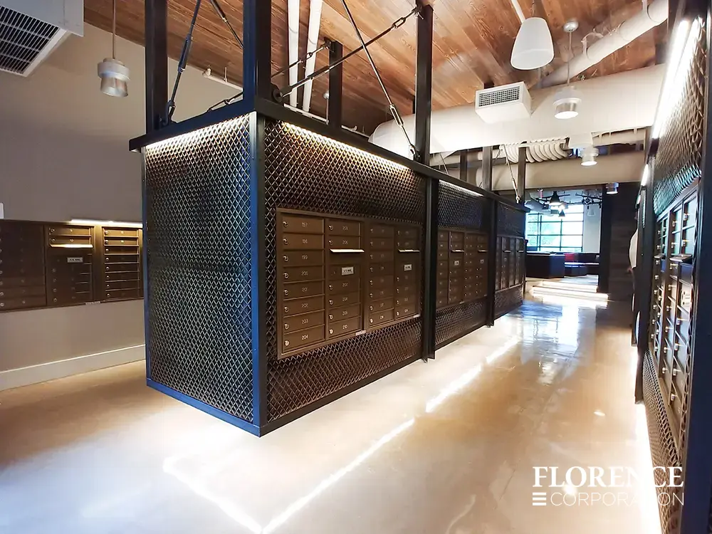 versatile-4C-indoor-install_026 Recessed mount versatile™ 4C mailboxes in dark bronze installed in suspended black metal fixture hanging from ceiling in modern mail room with architectural design touches