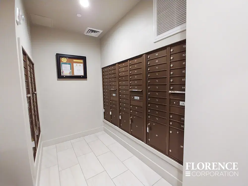 versatile-4C-indoor-install_036 Recessed mount versatile™ 4C mailboxes in antique bronze installed in mailroom with white walls, trim and tile floor