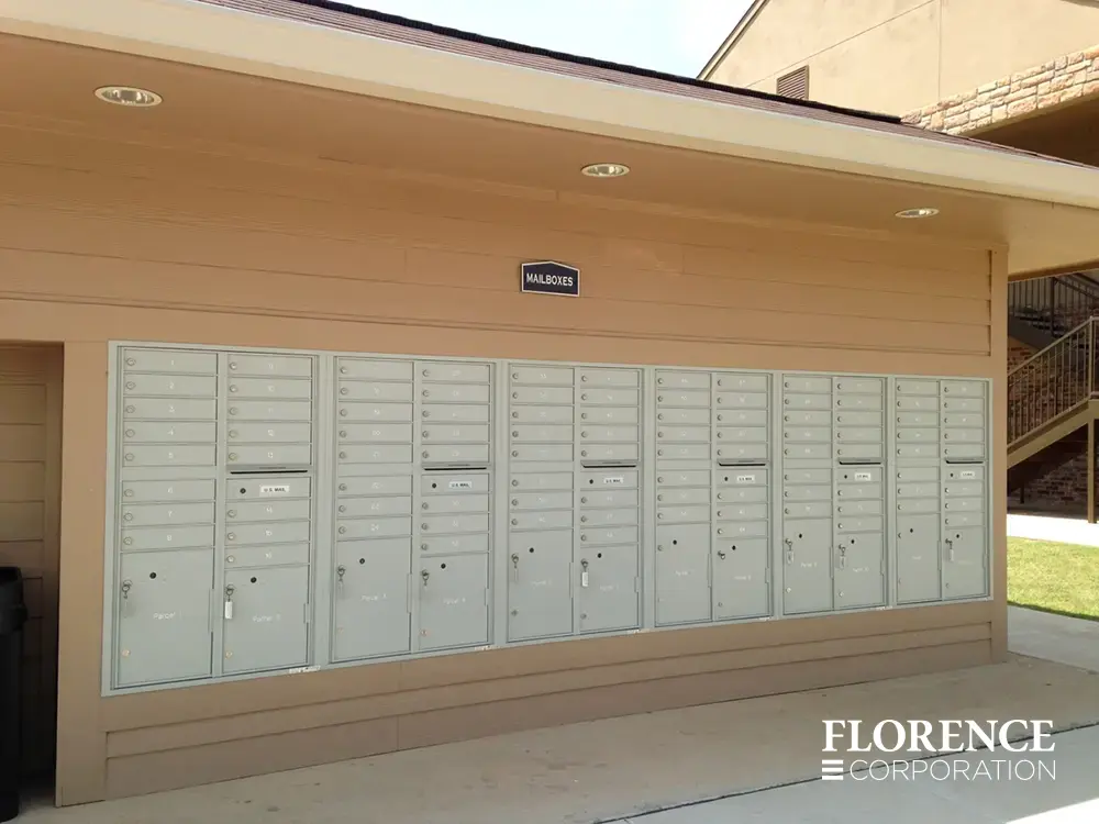 versatile-4C-recessed-indoor-21 recessed mounted versatile™ 4C mailboxes in silver speck installed outdoors on side of multifamily community building
