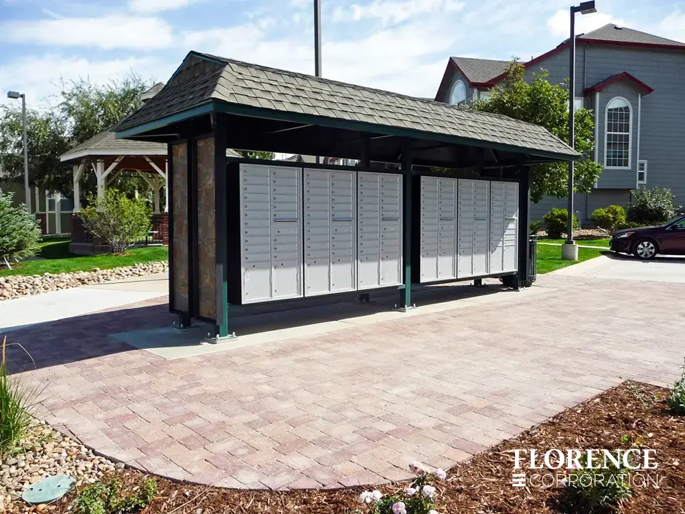 versatile-4C-recessed-indoor-30 recessed mounted versatile™ 4C mailboxes in silver speck installed outdoor in green metal covered fixture in townhome community