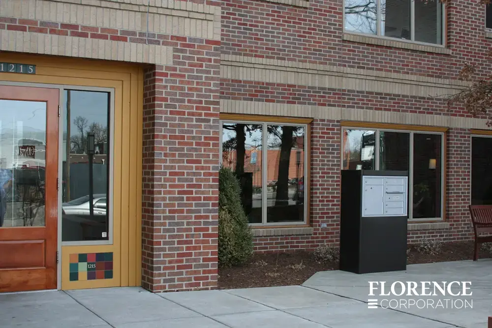 4C-versatile-surface-depot_015 versatile™ 4C mailbox installed in dark bronze freestanding depot cabinet outdoors in front of commercial brick building space