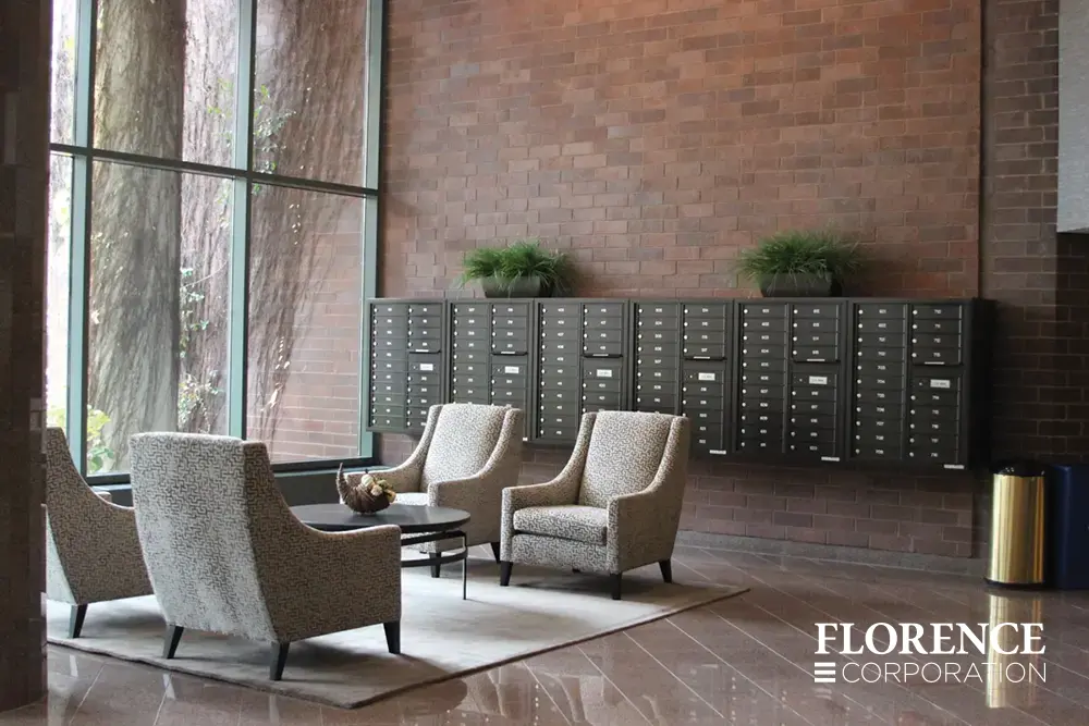 4C-versatile-surface-depot_001 surface mounted versatile™ 4C mailboxes in dark bronze mounted with matching collar indoor on red brick wall near four chairs and a table