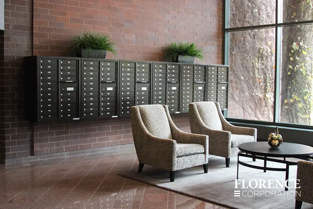 4C-versatile-surface-depot_005 surface mounted versatile™ 4C mailboxes in dark bronze located in lobby area of modern commercial building space with chairs and table near large window