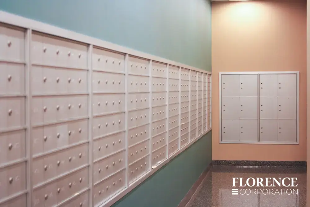 1400 Series 4B+ horizontal mailboxes and parcel lockers in anodized aluminum installed recessed on blue and orange walls