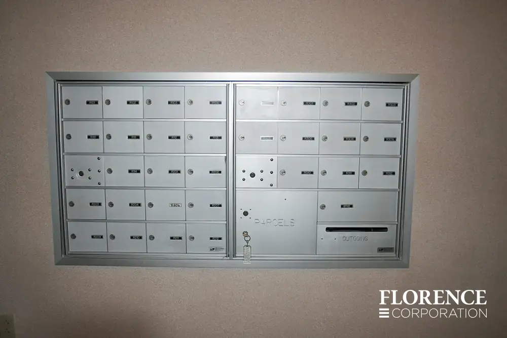 1400 Series 4B+ horizontal mailboxes in anodized aluminum installed recessed mounted in wall with parcel locker and outgoing mail slot