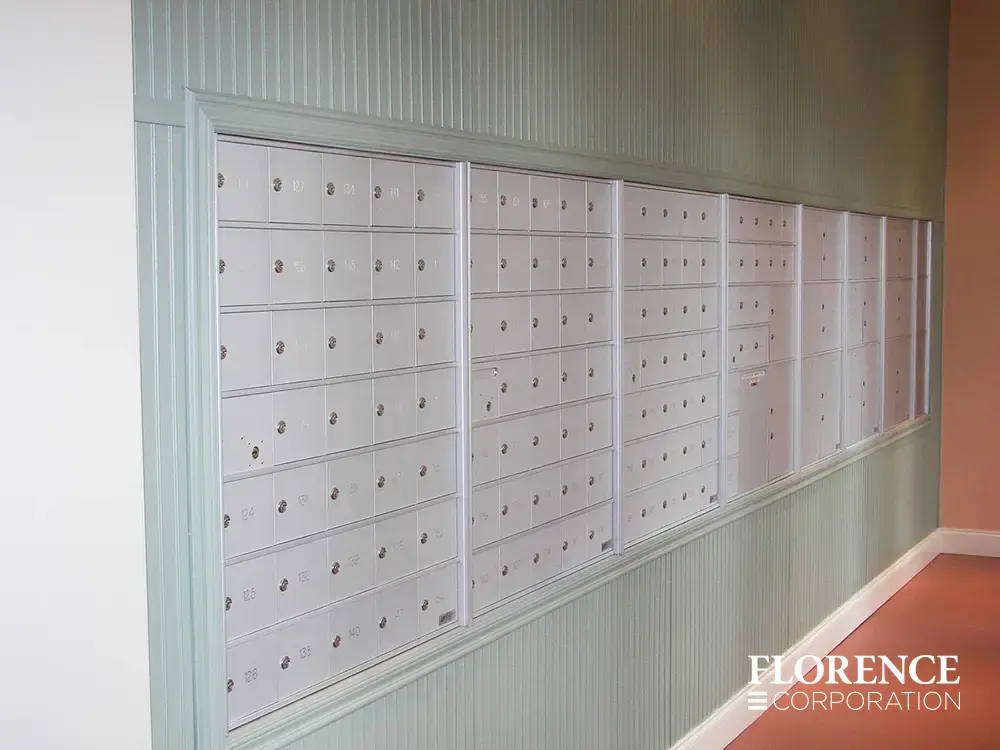 1400 Series 4B+ horizontal mailboxes in anodized aluminum recessed mounted into green slated wall with red floor