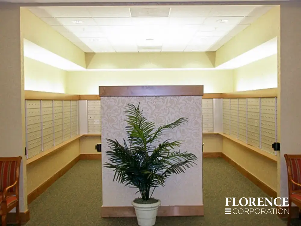 1400 Series 4B+ horizontal mailboxes in anodized aluminum installed in u-shaped well lit mailroom with green plant