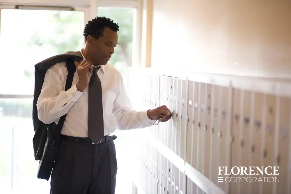 african american man in business attire checking mail in bank of 1250 series vertical 4B+ mailbox recessed-mounted in entry way of commercial building