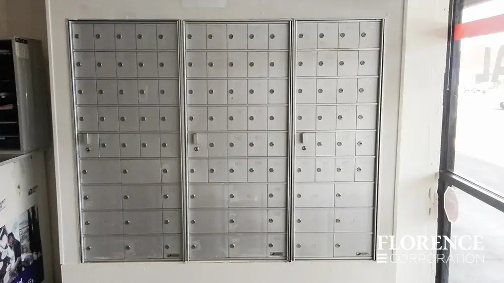 1600 Series 4B+ horizontal mailboxes in anodized aluminum installed recessed in white wall of commercial building entry space