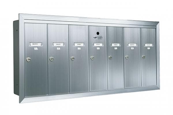 Silver vertical mailbox solutions with locks and name tags on the doors.